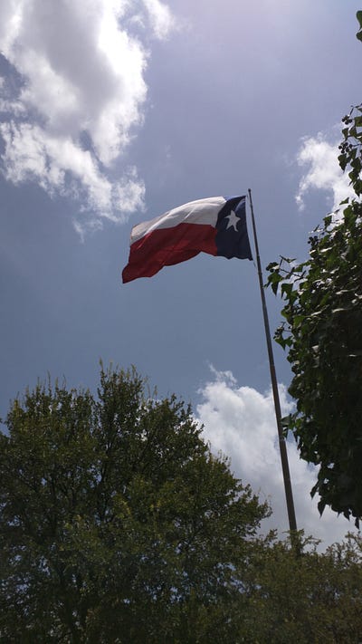 Our Airbnb apartment and a GIANT Texas flag